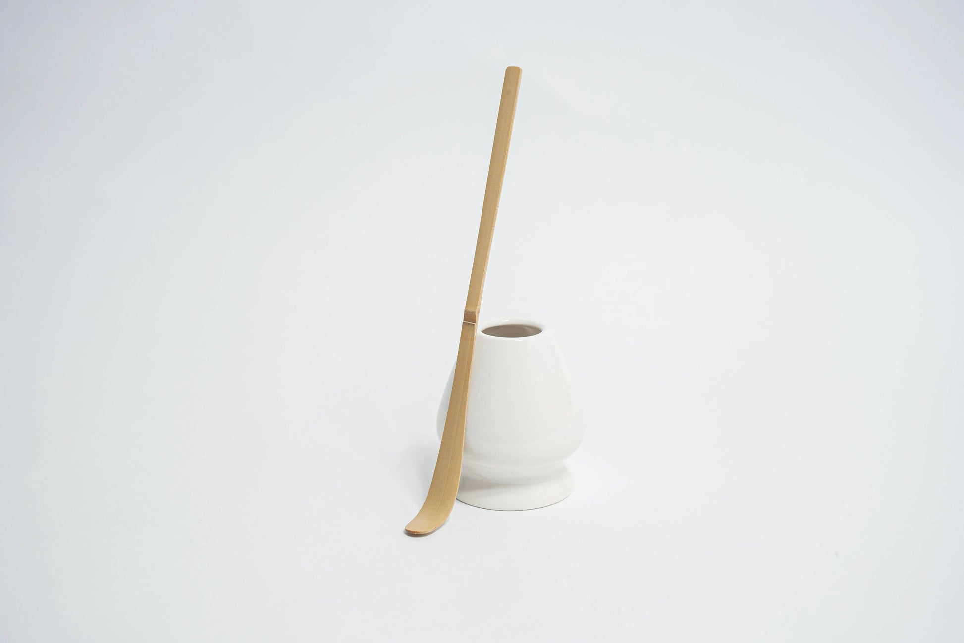 Japanischer Matcha Löffel für die Dosierung neben Matcha Schneebesen Aufbewahrungskeramik 